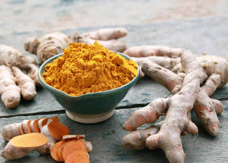 Turmeric-powder-and-turmeric-on-wooden-background