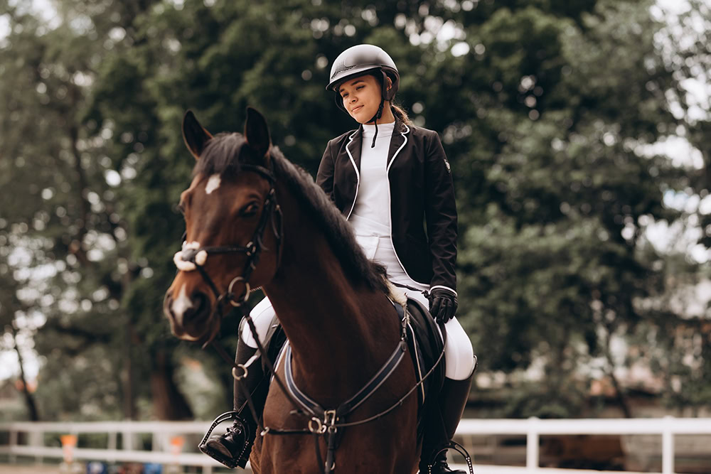 woman riding a horse wearing helmet