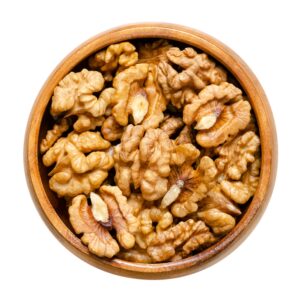 Walnut kernel halves in a wooden bowl
