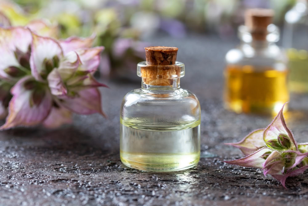 small bottle of fresh clary sage essential oil