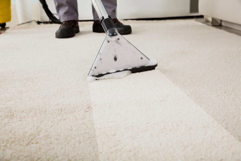 person-cleaning-carpet-with-vacuum-cleaner