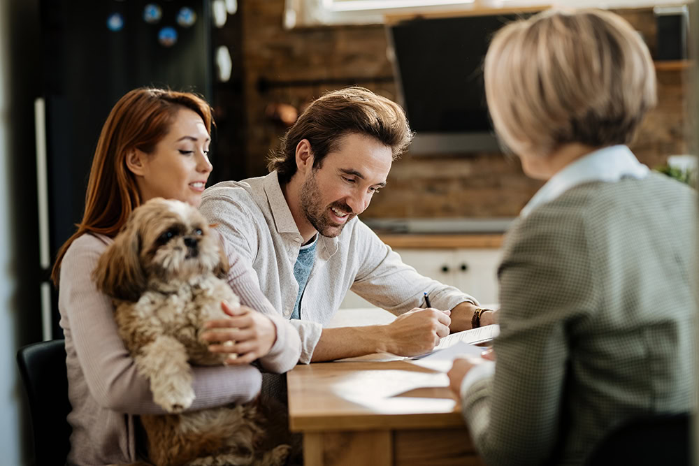 insurance advisor discussing with pet owners