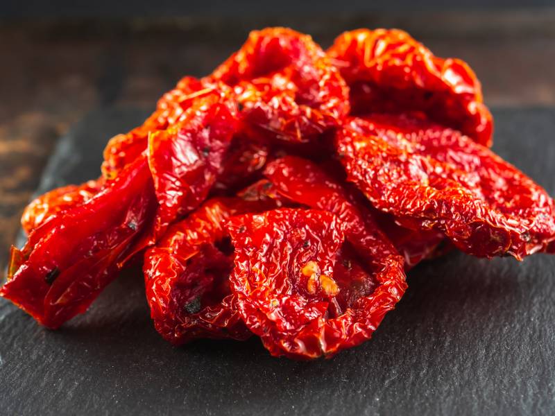 A slide of sun-dried tomatoes are on Natural Slate Dishes