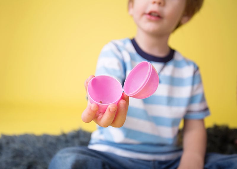 Child showing an open plastic easter egg