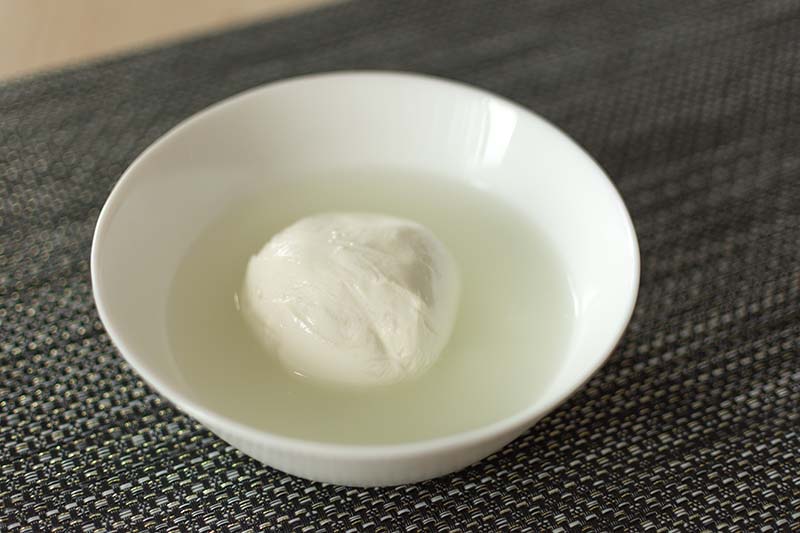 Mozzarella cheese in a bowl with brine