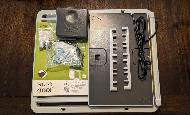 Omlet Automatic Chicken Coop Door - coop door on the table