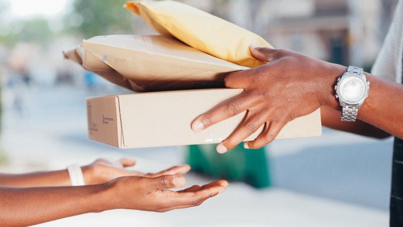 Person Handing Over Packages boxes