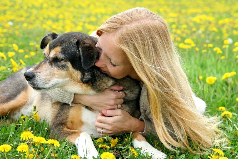 woman hugging dog_Christin Lola, Shutterstock