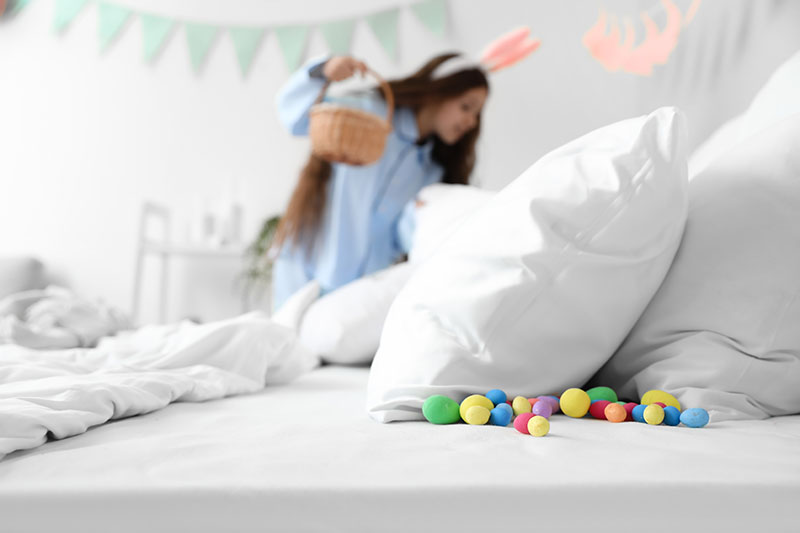 girl looking for easter eggs in bedroom