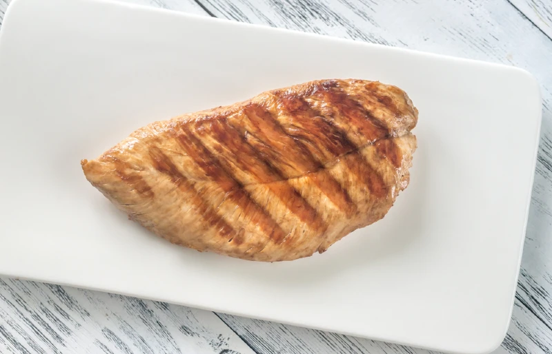 grilled turkey breast on white plate