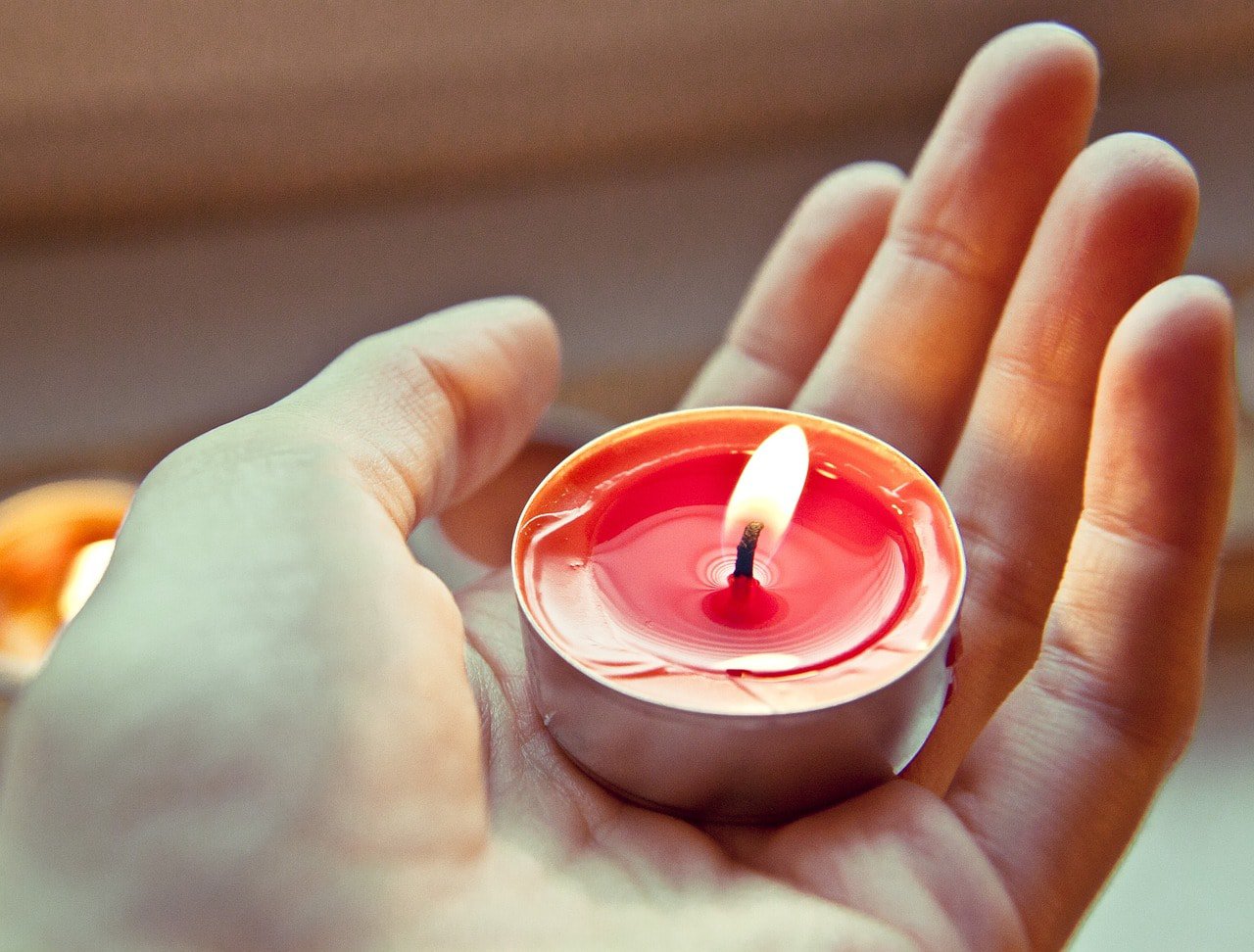 hand carrying a tealight candle