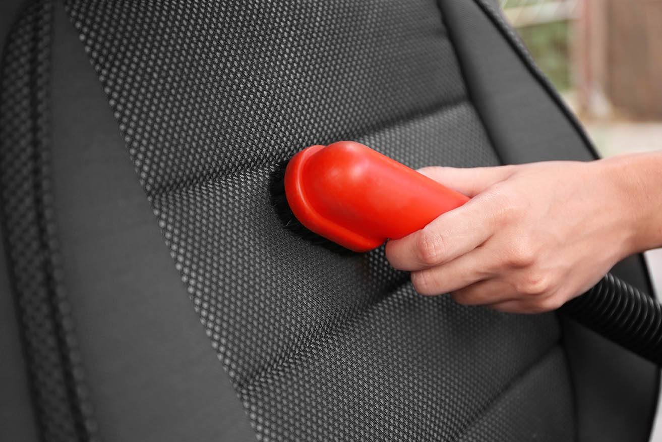 hand cleaning car seat