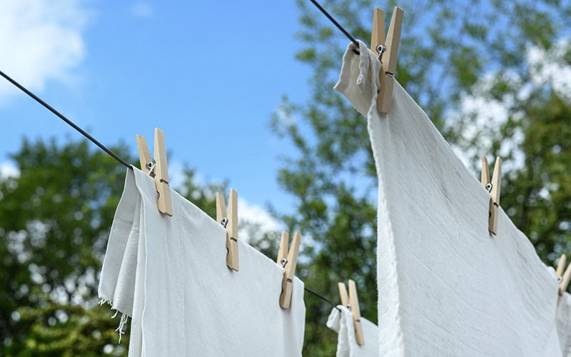 laundry hanging to dry outdoors under the sun