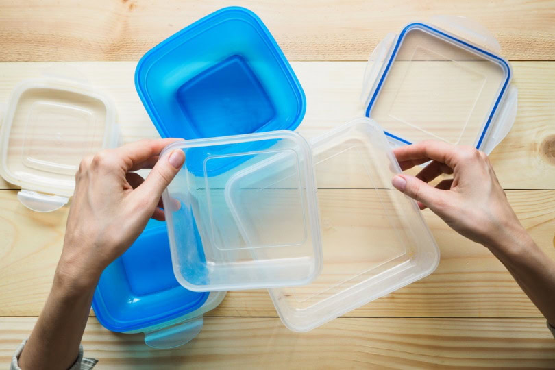 man holding plastic container