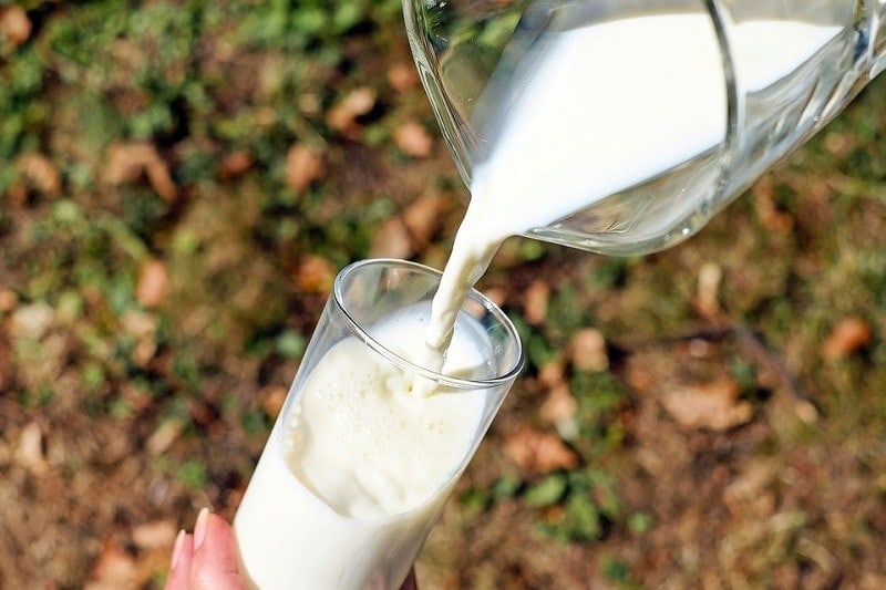milk being poured in a glass