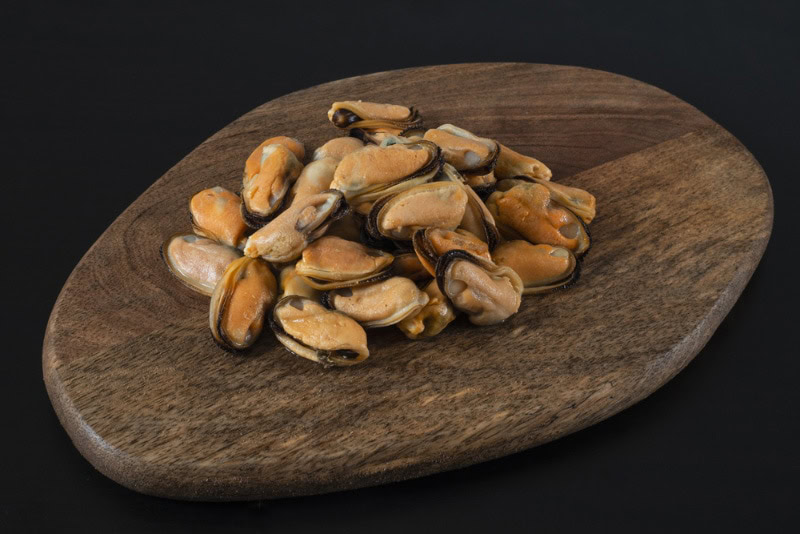 mussels without shells on a wooden board