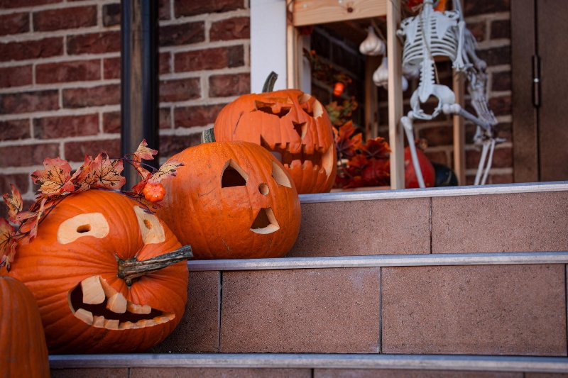 orange carved halloween pumpkins on outdoor stairs