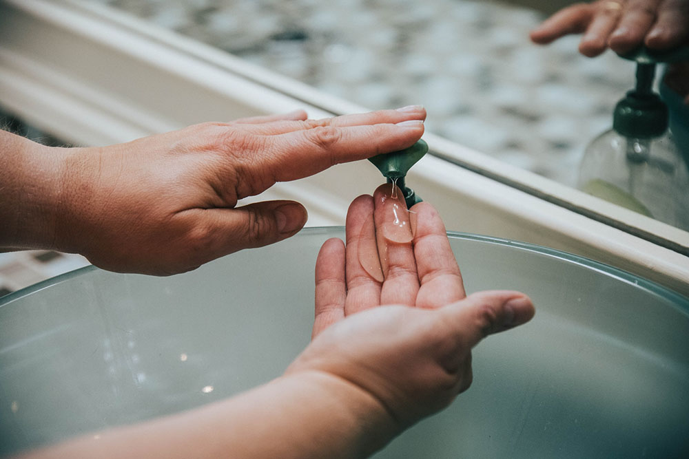 person putting hand soap on their hands