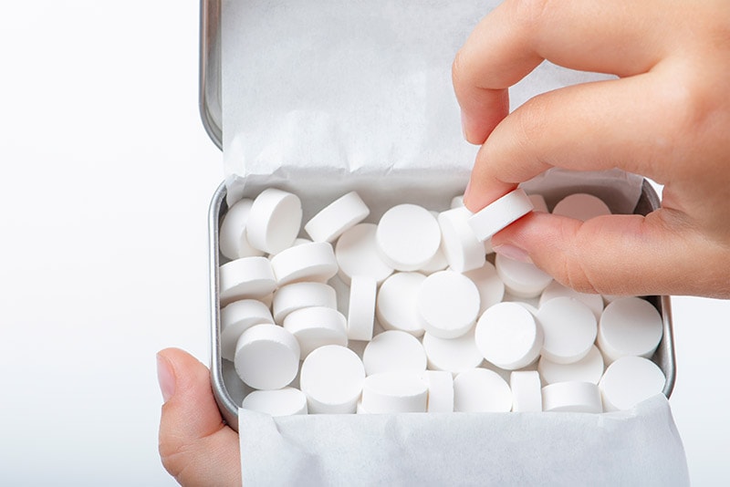 person taking a mint candy