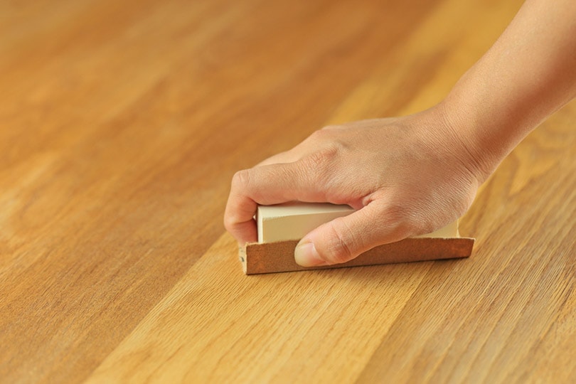 polishing a hardwood with sandpaper