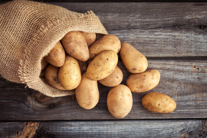 potatoes on wooden table