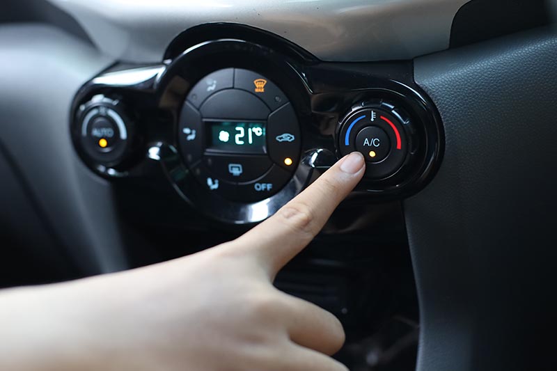 pressing ac button of car