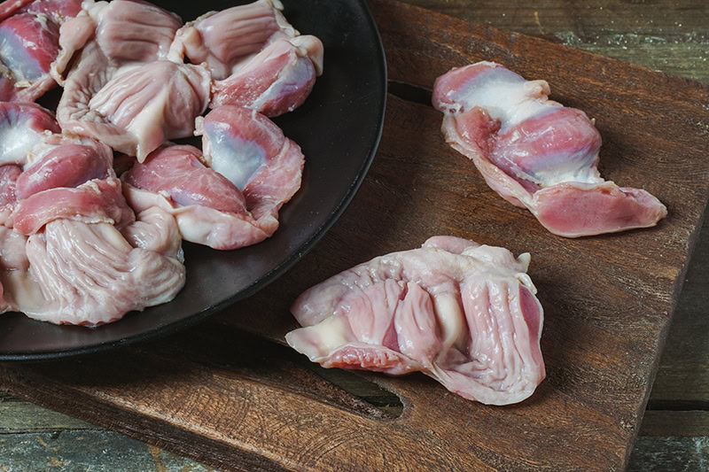 raw chicken gizzards on a plate
