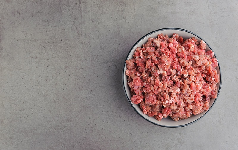 raw meat on pet food bowl