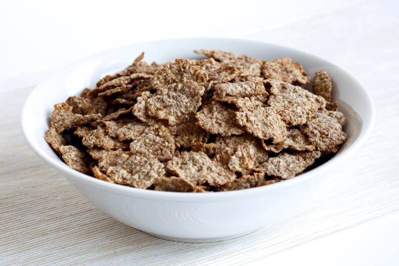 wheat bran breakfast cereal with no milk in a bowl