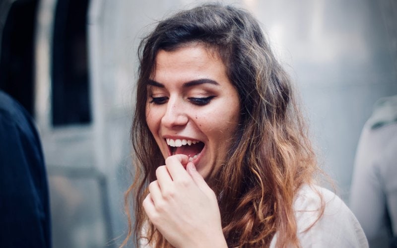woman touching her mouth with her hand