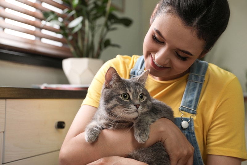 young woman hugging her cat