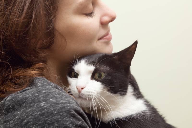 young woman with monochrome black and white cat